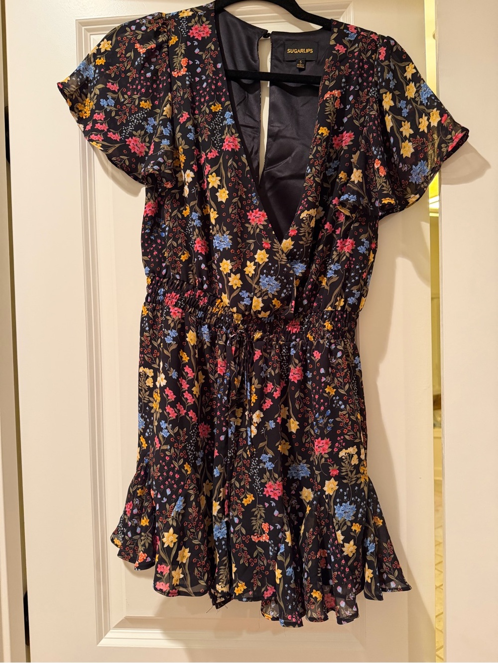 Sugarlips Black Floral Wrap Romper with Pink, Blue & Yellow Blooms